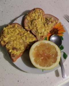 Quick Breakfast: Ackee and Saltfish spread on toast, served with half a grapefruit.